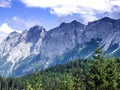 Alpine landscape: the view over the green valley, mountains and Royalty Free Stock Photo