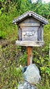 Alpine mailbox, weathered gray wood with cow carving