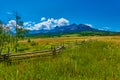 Alpine meadow with fence and view of Mount Sneffels Range in the background Royalty Free Stock Photo