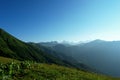 Alpine meadows and mountains in the mist blue with beautiful summer landscape Royalty Free Stock Photo