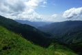 Alpine meadows and mountains in the mist blue with beautiful summer landscape Royalty Free Stock Photo