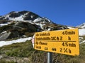 Alpine mountaineering signposts and markings in the mountainous area of the Albula Alps and above the mountain road pass Fluela