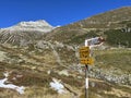 Alpine mountaineering signposts and markings in the mountainous area of the Albula Alps and above the mountain road pass Fluela