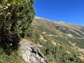 Alpine mountaineering signposts and markings in the mountainous area of the Albula Alps and above the mountain road pass Fluela