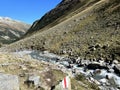 Alpine mountaineering signposts and markings in the mountainous area of the Albula Alps and above the mountain road pass Fluela