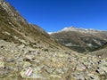 Alpine mountaineering signposts and markings in the mountainous area of the Albula Alps and above the mountain road pass Fluela