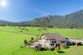 Alpine mountains summer green meadow in valley landscape Royalty Free Stock Photo