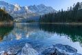 Alpine panorama of Lake Eibsee with Germanys highest mountain Zugspitze in the background on a sunny afternoon in autumn