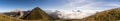 Alpine panorama with shining clouds