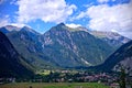 Alpine peaks and valley under a blue cloudy sky in Nassereith, Tirol