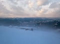 Alpine resortr ski lift with seats going over the sunset mountain skiing slopes in extremally windy weather Royalty Free Stock Photo