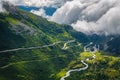 Alpine road with serpentines over the clouds, Furka pass, Switzerland Royalty Free Stock Photo