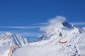 Alpine ski resort of snow-covered rocks bright winter day. Royalty Free Stock Photo