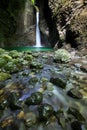 Alpine spring with waterfall falling into a narrow gorge