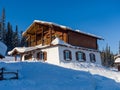 Alpine-style hotel in the Gornaya Salanga ski resort. Winter sunny day Royalty Free Stock Photo