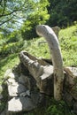 Alpine style wooden fountain in Italy Royalty Free Stock Photo