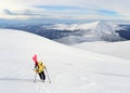 Alpine touring skier hiking in winter mountains.