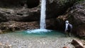 Alpine trekking in a waterfall with turquoise water