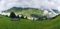 Alpine village in foggy clouds