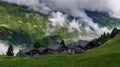 Alpine village in foggy clouds