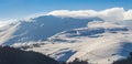 Alpine winter scenery, with fresh snow and mist, on a bright day