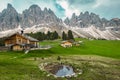 Alpine wooden chalets on the green fields, Dolomites, Italy Royalty Free Stock Photo