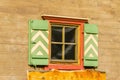 Alpine wooden house facade with orange window Royalty Free Stock Photo