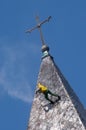 Alpinist cleans church roof Royalty Free Stock Photo