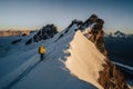 An alpinist climbing alpine peak in Switzerland
