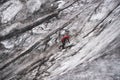 Alpinist climbing on ice wall cowered by dust on glacier Mer De Glace, Mont-Blanc massif in French Alps. Royalty Free Stock Photo