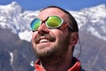 Alpinist looking at summit, mountain background