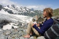 Alpinist looking to map in wild mountains Royalty Free Stock Photo