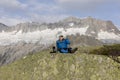 Alpinist makes a tea break before breathtaking mountain views