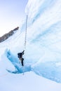 Alpinist mountaineer climb ladder over ice crevasse Royalty Free Stock Photo