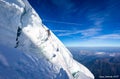 Alpinist mountaineer climbing dangerous ice crevasse crack Royalty Free Stock Photo