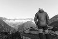 Alpinist stands during the dawn of dawn in front of the alps Royalty Free Stock Photo