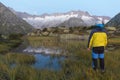 Alpinist stands during the dawn of dawn in front of the mighty mountain scenery Royalty Free Stock Photo