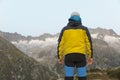 Alpinist stands during the dawn of dawn in front of the mighty mountain scenery Royalty Free Stock Photo