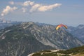 Alps. Dachstein Mountains. Austria. Paraplaner gliding in blue sky with view on Alpine mountains on paraplane Royalty Free Stock Photo