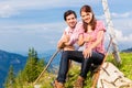 Alps - Hiking Couple takes break in mountains Royalty Free Stock Photo