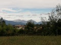 Alps and mountains in farmlands landscape in italy