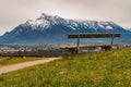 Alps mountains scenery landscape snowy range peak background with lonely wooden bench foreground beautiful view point peaceful and Royalty Free Stock Photo