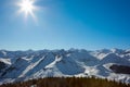 Alps mountains with snow in winter, sun and blue sky Royalty Free Stock Photo