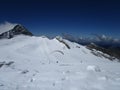 The Alps - rocky mountains with snow in summer, Austria, blue sky with paraglider