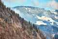 Alps with village houses, snow, forest, blue lake and misty clouds Royalty Free Stock Photo