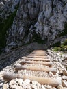 Alpspitze hiking track - walking downhill on natural wooden rocky mountains stairs in bavarian Alps Royalty Free Stock Photo