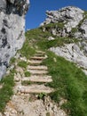 Alpspitze hiking track - walking uphill on natural wooden rocky mountains stairs in bavarian Alps Royalty Free Stock Photo