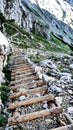 Alpspitze hiking track - walking downhill on natural wooden rocky mountains stairs in bavarian Alps Royalty Free Stock Photo