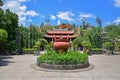 Large censer pot in Long Son Pagoda Buddhist temple with large white Buddha statue at the top in Nha Trang, Vietnam