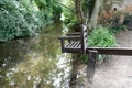 Women`s punishment. Ducking stool located by a riverside. England